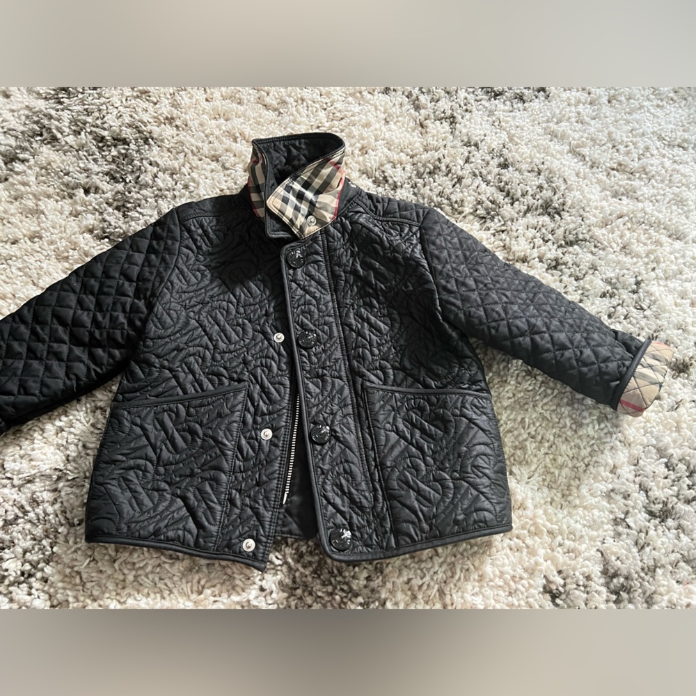 Black Burberry jacket comes with attachment hood